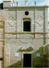 La facciata della chiesa è caratterizzata dalla sua superficie, realizzata in laterizi a vista, decorata unicamente da una cornice dalle grandi proporzioni di forma ellittica che domina il portale di ingresso  (foto Tota)